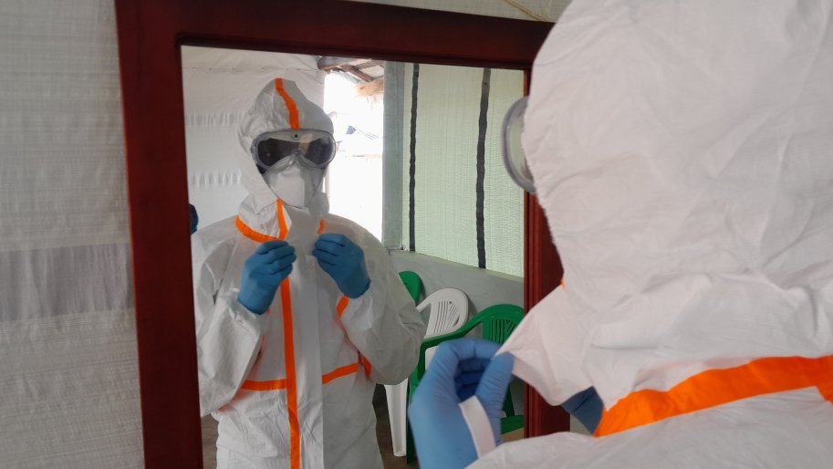 A nurse is being dressed-up with a Personal Protective Equipment (PPE) before he enters the area of the Mubende Ebola Treatment Center where the patients infected with Ebola are being taken care of.