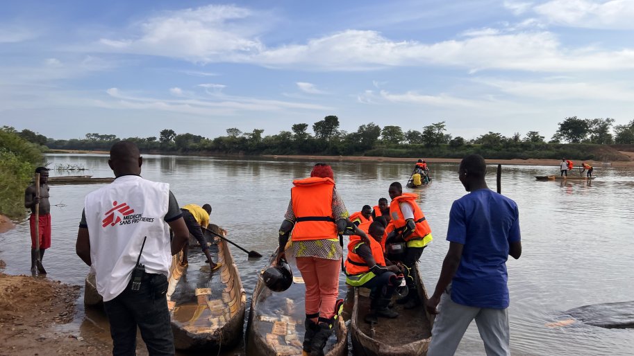Une équipe médicale de Médecins Sans Frontières embarquant sur une pirogue.