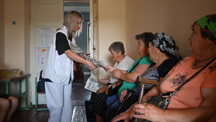 Olena Liubarska, promotrice de santé chez MSF, distribue le journal.
