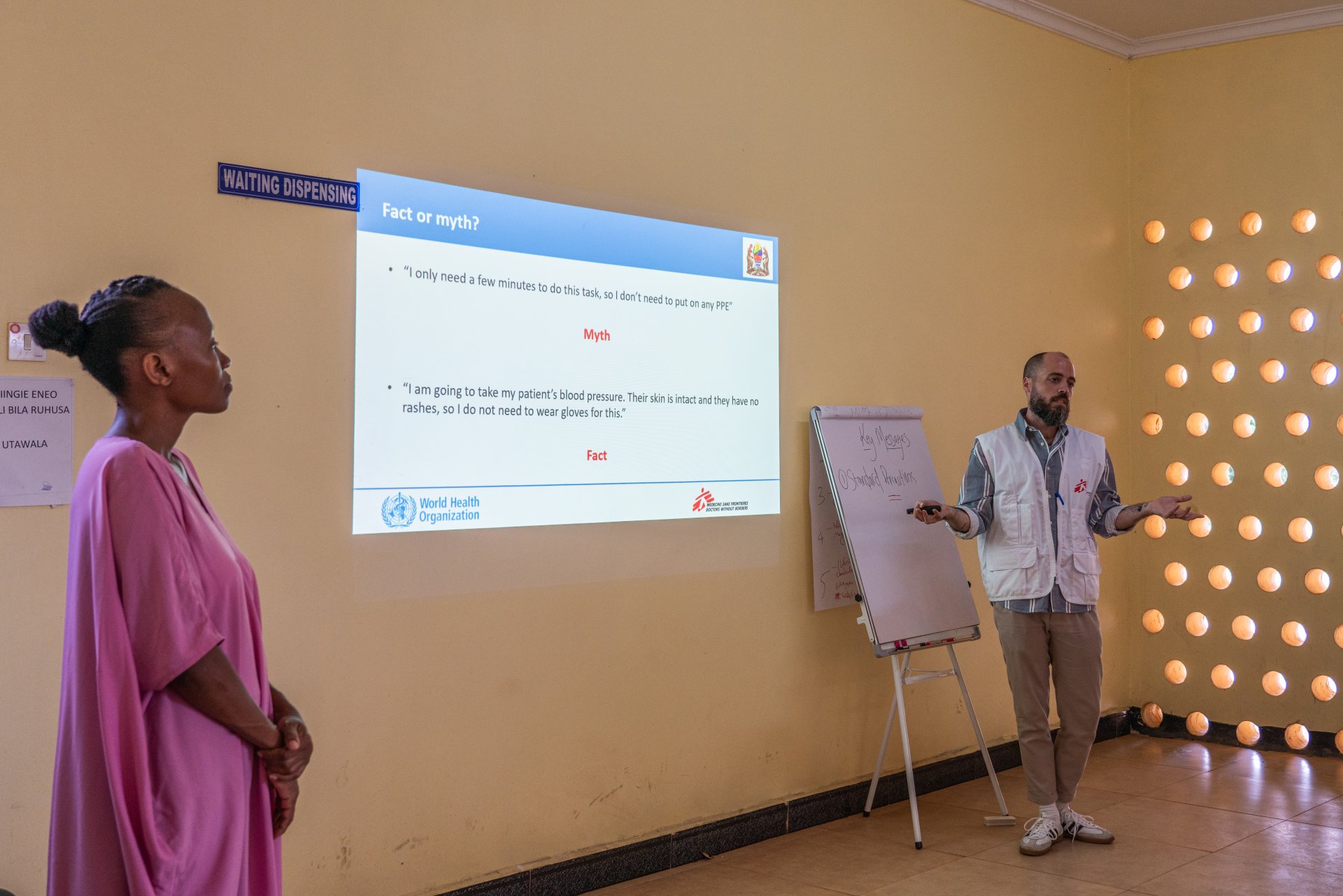 During a full day of training by MSF technical experts at the Marburg treatment unit, Anthony Twyman, MSF infection prevention and control manager, with the help of Jackline John Ngelela, MSF translator, explains key IPC pillars and the behaviour to adopt in order to avoid contamination in the health centres where the participants to the training work. 
