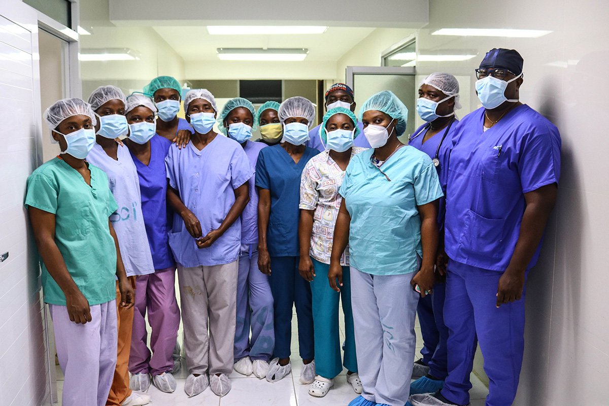 Ein medizinisches Team mit zwei Chirurgen und einer Operationspflegefachfrau