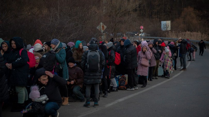 Des centaines de personnes font la queue pour traverser à pied la frontière slovaque depuis la ville d'Uzhhorod, dans la région de Transcarpathie en Ukraine, le 6 mars 2022. 