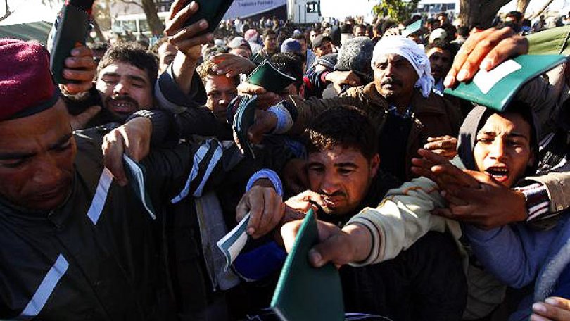 Après avoir traversé la frontière de Ras Jdir, des réfugiés égyptiens ayant fuit la Libye tentent de se faire enregistrer dans un camp de réfugié. Tunisie, 25.02.2011