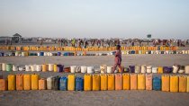 Every morning the camp residents rush to the water point to line up their buckets to be filled. Access to water is a major problem for the displaced.
